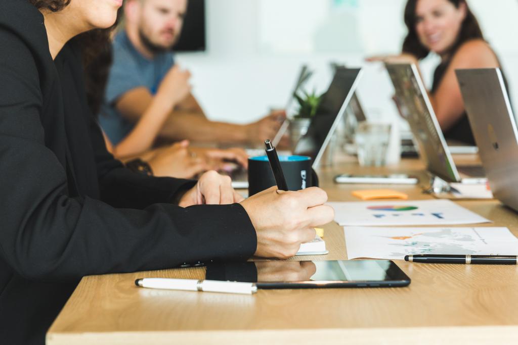 woman taking notes during team meeting 1024x683 1