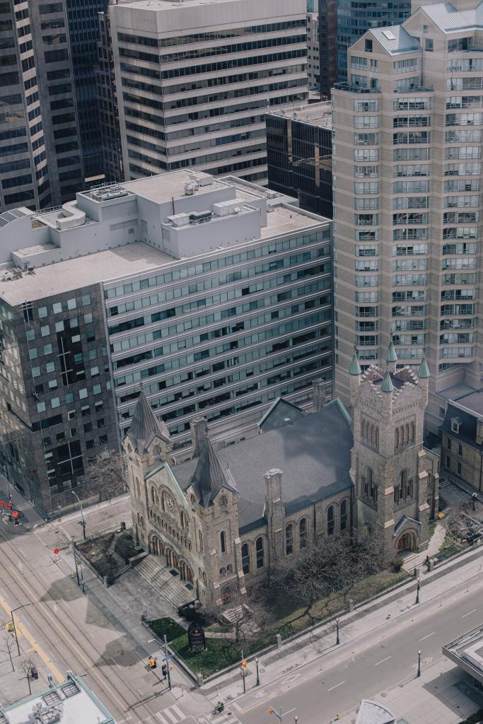 aerial view of a church with tall building surrounding it 683x1024 1