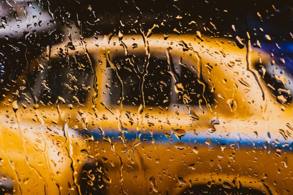 a yellow taxi behind a rain spattered window 1024x683 1