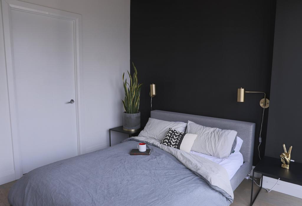 photo of a bedroom with black and gold design 1024x699 1