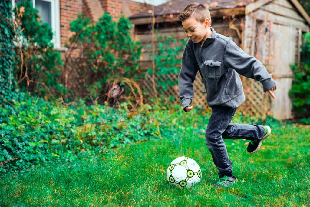 young boy kicking ball 1024x683 1