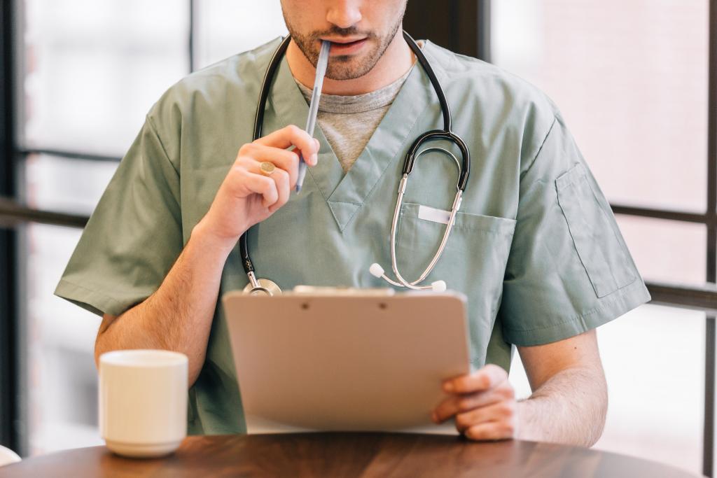 doctor looking at clipboard 1024x683 1